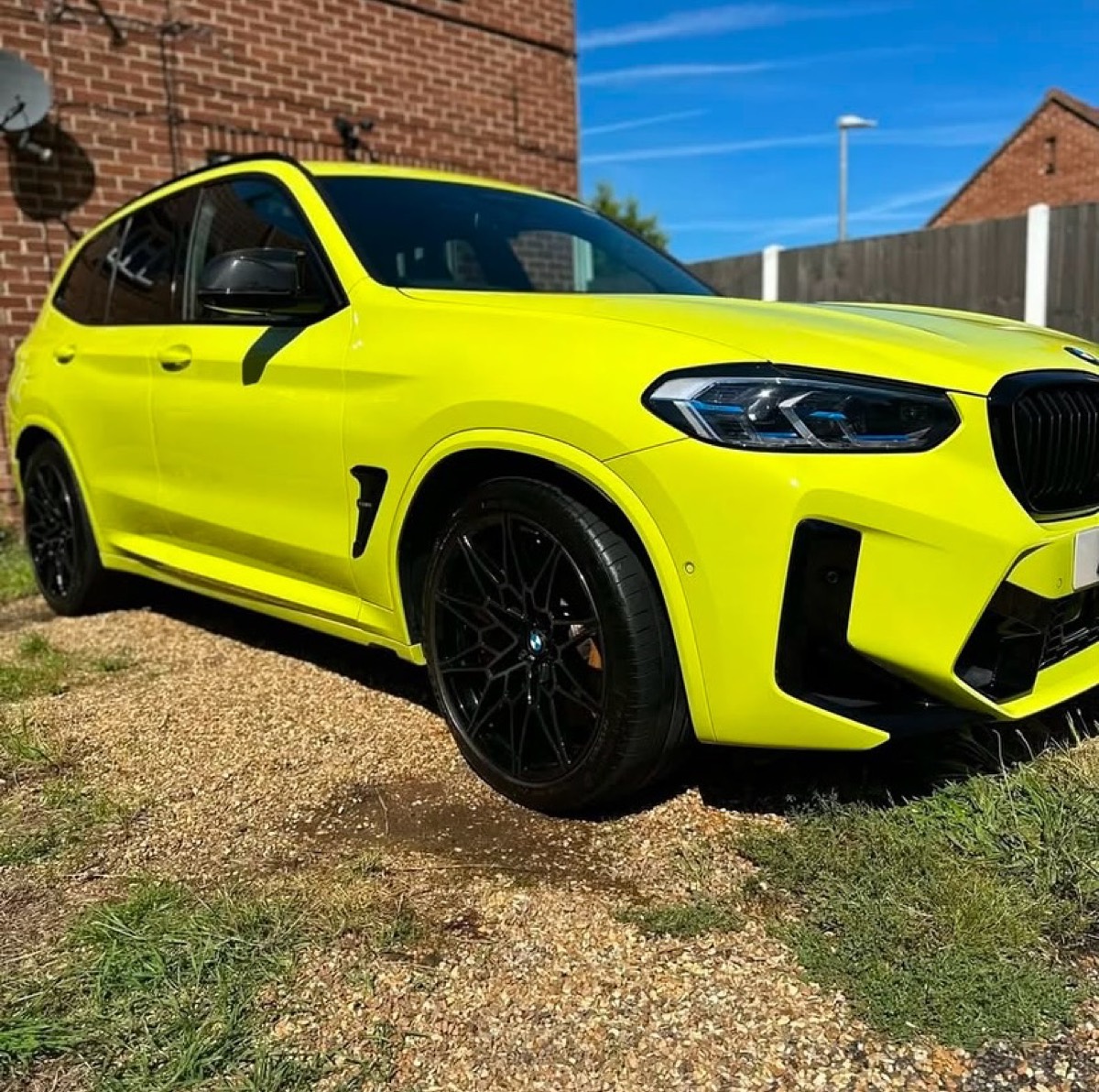Bright yellow BMW X3 M cleaned and gleaming after a wash
