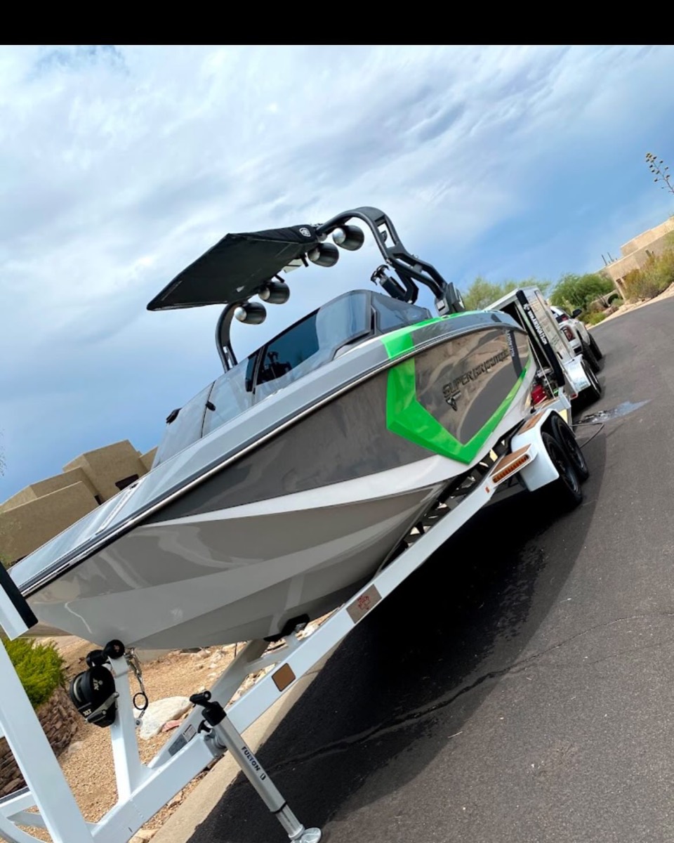 Wakeboarding boat washed and detailed on its trailer